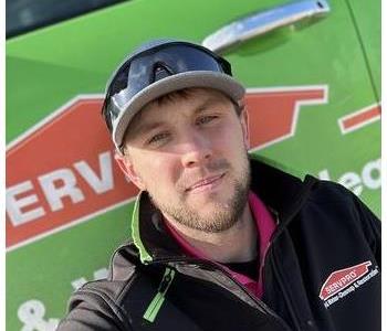 Operations manager in front of SERVPRO vehicle