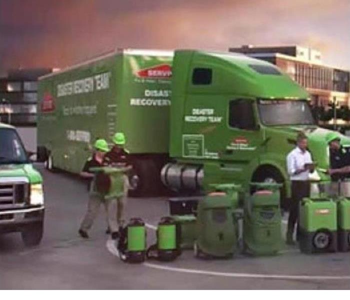 Image of SERVPRO semi with workers around it